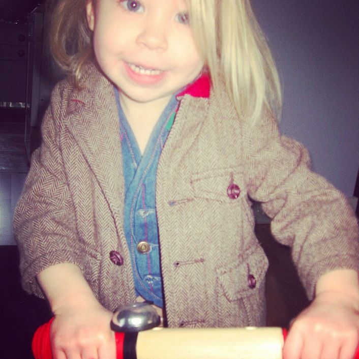 little girl wearing suit riding balance bike skuut instagram