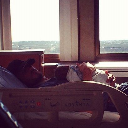 father holding newborn hospital bed instagram