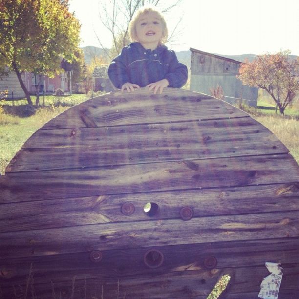 little boy on wooden spool instagram
