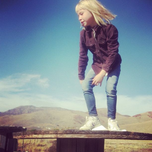 little girl on wooden spool instagram