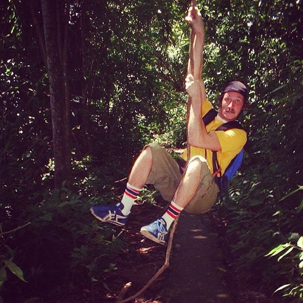 man swinging on vine costa rica instagram