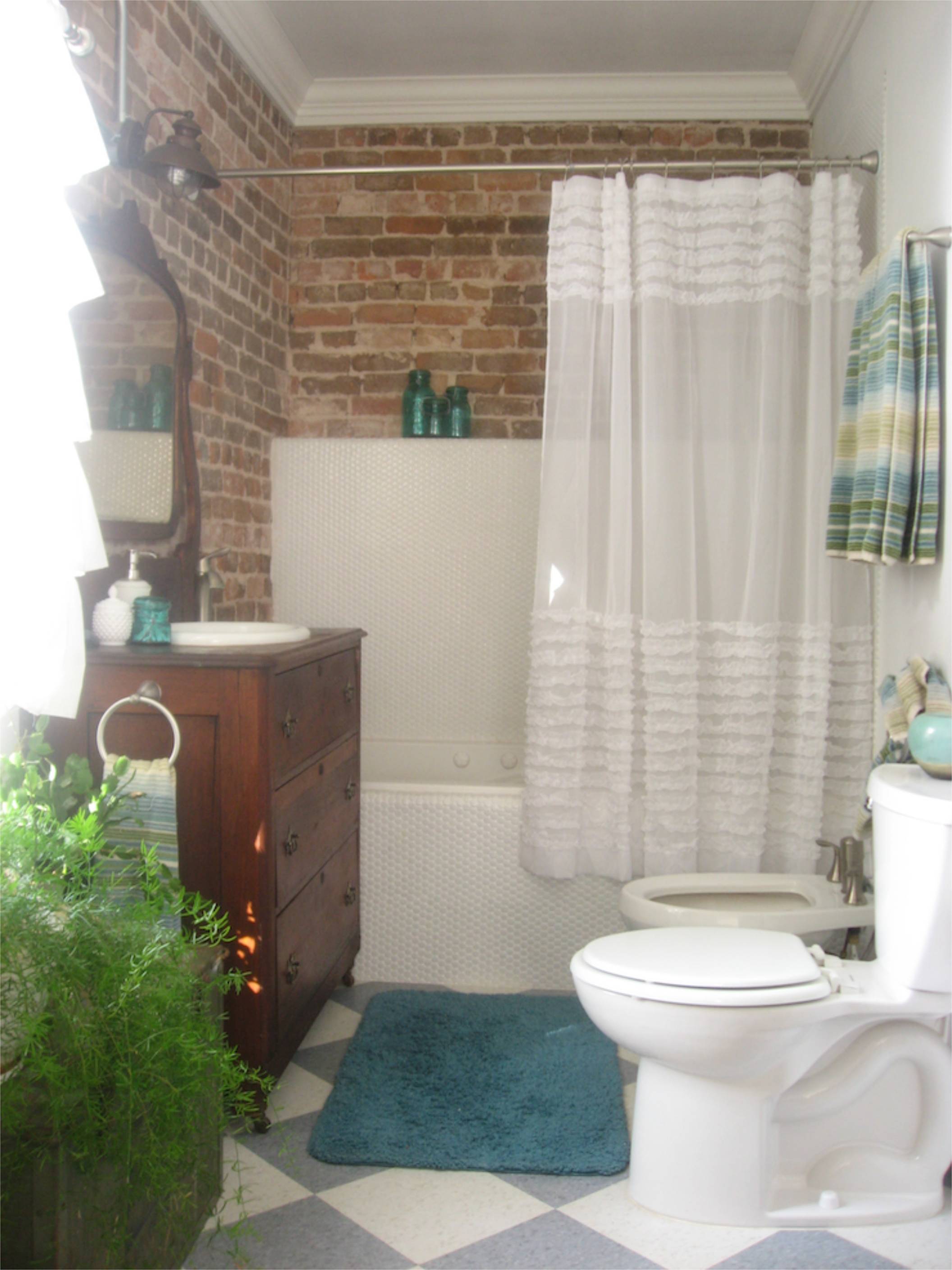 brick wall antique vanity penny tile bathroom